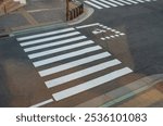 Crosswalk in the city street with striped white lines. Crossing area look from top view.