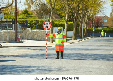 Crosswalk Guard (woman) Holding Stop Sign.