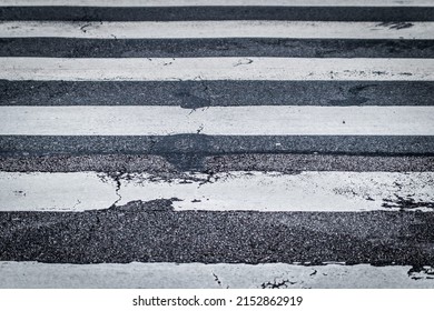 Crosswalk marking on roadway with abrasion marks