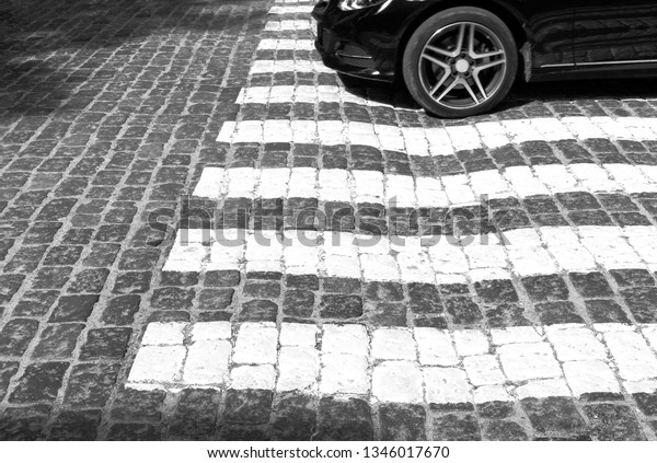 crosswalk. old paved stone road. black and white        \
                    \
