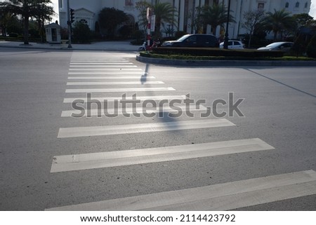 Crosswalk on the road for safety when people walking cross the street, Pedestrian crossing on a repaired asphalt road, Crosswalk on the street for safety, logistic import export and transport industry