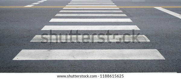 crosswalk on the road for safety when people\
walking cross the street, Pedestrian crossing on a repaired asphalt\
road, Crosswalk on the street for safety, logistic import export\
and transport\
industry