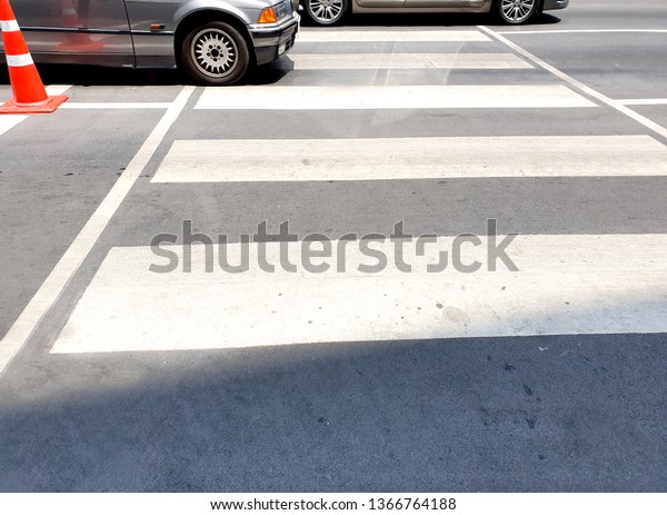 Crosswalk\
on the road for safety when people walking cross the street. A\
crosswalk for pedestrians crossing the street.\
