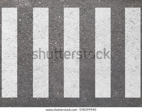 crosswalk on the road for safety when people\
walking cross the\
street.