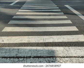 Crosswalk sign on the road helping people crossing the street - Powered by Shutterstock