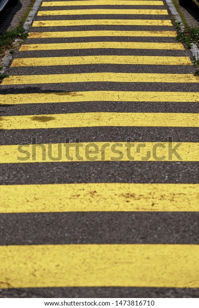Crosswalk yellow lines on the road. zebra yellow\
pedestrian crossing