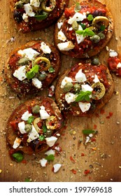 Crostini With Roasted Tomato Salsa,  Olives, Capers, Feta Cheese And Fresh Oregano