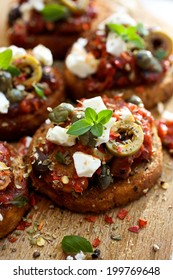 Crostini With Roasted Tomato Salsa,  Olives, Capers, Feta Cheese And Fresh Oregano