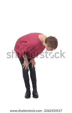 crouched woman looking at the ground to the side looking for something on white background