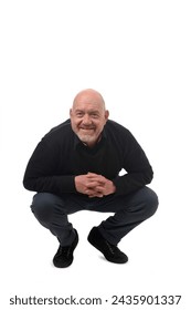 crouching man looking at camera on white background