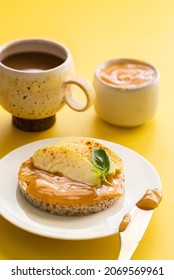 Crounchy Buckwheat And Rice Snack With Almond Butter And Apple Decorated With Cinnamon And Basil On Yellow Background With Cup Of Coffee  