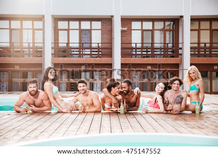 Similar – Young friends holding woman on top of surfboard