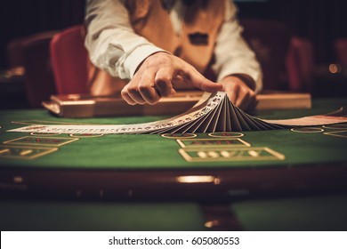 Croupier behind gambling table in a casino.