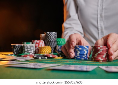 The Croupier At The Gaming Table In The Casino, Raises Bets With Chips. Gaming Business Black Jack, Poker. With Space For Design.