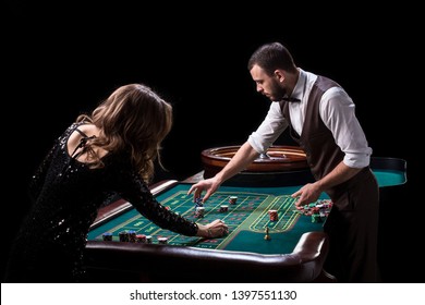 Croupier And Woman Player At A Table In A Casino. Picture Of A C