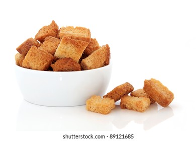 Crouton Stack In A Porcelain Bowl And Scattered Isolated Over White Background.