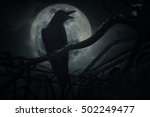 Crow sit on dead tree trunk and croak over fence, old grunge castle, moon and cloudy sky, Mysterious background, Halloween concept