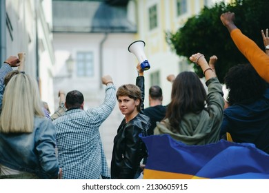 Crowd of activists protesting against Russian military invasion in Ukraine walking in street. - Powered by Shutterstock