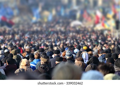 Crowd of anonymous people on street in city center, selective focus