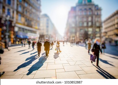 Crowd Of Anonymous People Walking On Busy City Street