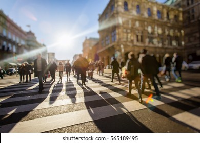 Crowd of anonymous people walking on busy city street - Shutterstock ID 565189495