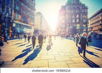 Crowd Of Anonymous People Walking On Busy And Sunny City Street