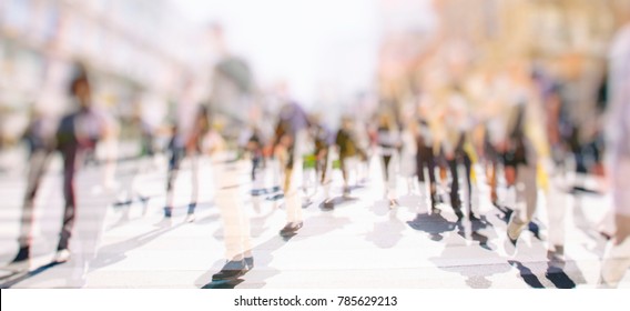 Crowd of anonymous people walking on busy city street, urban city life background