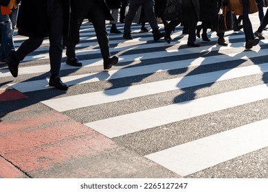Crowd of Asian business people walking city street crosswalk with traffic on the road at Shibuya crossing, Tokyo, Japan in the morning. Man and woman tourist shopping and travel on holiday vacation. - Shutterstock ID 2265127247