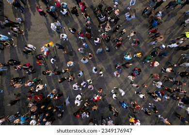 crowd background. An aerial shot of the people gathered for an event. Crowed open-air meeting people shot from a height. A mass people gathered to celebrate an event. Open-air night festival.