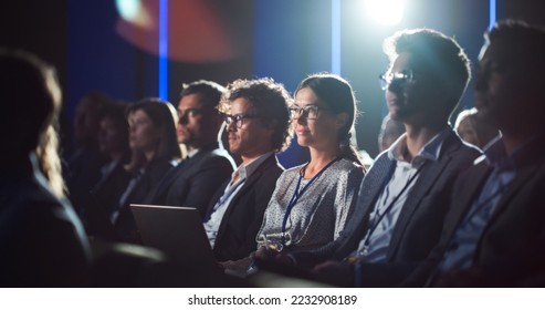 Crowd of Business People in Dark Conference Hall Watching an Innovative Inspiring Keynote Presentation. Business Technology Summit Auditorium Room Full of Corporate Delegates. - Shutterstock ID 2232908189