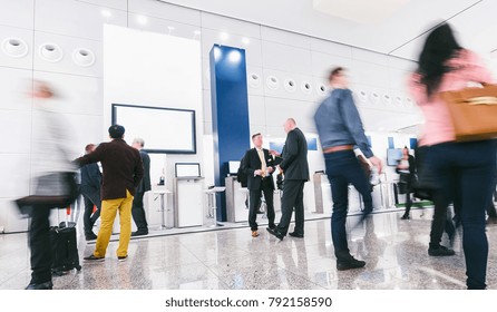 crowd of business people at a trade show booth