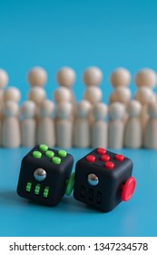 Crowd Calm Concept. Answer How To Calm The Crowd. Cube Stress Reliever And Wooden Figures On A Blue Background. Vertical Photo