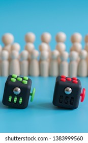 Crowd Calm Concept. Cube Stress Reliever And Wooden Figures On A Blue Background. Vertical Photo