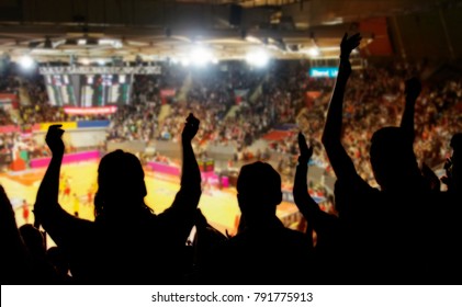 crowd cheering at basketball stadium