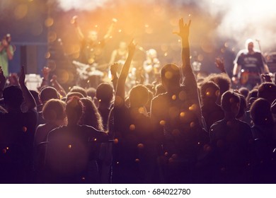 Crowd at concert - Cheering crowd in front of bright colorful stage lights - Shutterstock ID 684022780