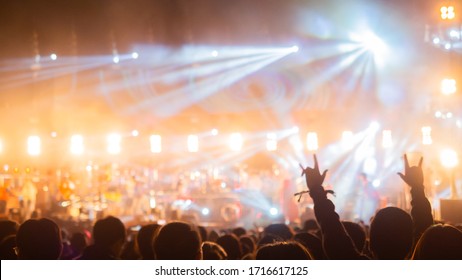 Crowd At Concert - Summer Music Festival In Front Of Bright Stage Lights. Dark Background, Smoke, Concert Spotlights.people Dancing And Having Fun In Summer Festival Party Outdoor Copy Space