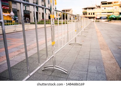 Crowd Control Barriers. Pedestrian Steel Barriers In The Evening. Galvanized Finish. 