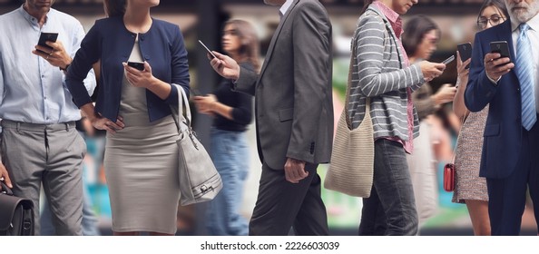 Crowd of distracted people walking in the city street and using smartphones, internet addiction concept - Shutterstock ID 2226603039