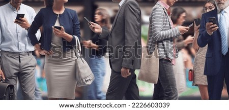 Crowd of distracted people walking in the city street and using smartphones, internet addiction concept