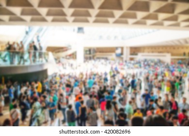 crowd inside a structure with unrecognizable people with blur effect