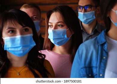 Crowd Of Masked People During The Covid-19 Pandemic - The Faces Of Young People Wearing Medical Masks - Sad Faces Of People From The Covid Epidemic