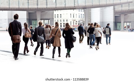 A Crowd Moving Against A Background Of An Urban Landscape. Young People.