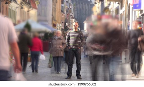 Crowd Moving Fast Near Man Standing Still Timelapse