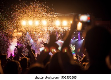 Crowd At Music Festival, Confetti, Hands. Shallow Depth Of Field Without Focus.