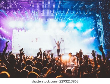 crowd partying stage lights live concert summer music festival - Powered by Shutterstock