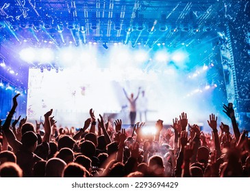 crowd partying stage lights live concert summer music festival - Powered by Shutterstock