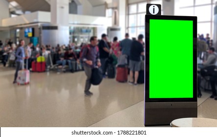 Crowd Of People At Airport Terminal With Green Screen Info Kiosk Or Info Display Mockup In Airport.