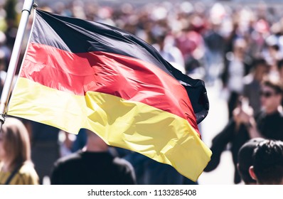 Crowd Of People As Background And Flag Of Germany