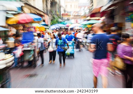 crowd of people in Chinatown in Bangkok, Thailand, with intentional zoom effect