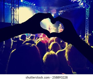  A Crowd Of People At A Concert Toned With A Retro Vintage Instagram Filter Effect And Hands Making A Heart Shape In The Foreground 